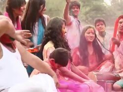 Family celebrating holi festival in the lawn  Stock Footage