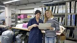 Operator talking with fashion designer about a fabric Stock Footage