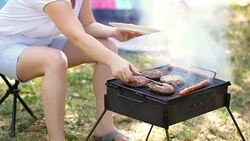 Young Mother Grilling Meat On Barbecue Stock Footage