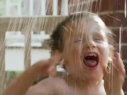 CU, FOCUSING, Boy (2-3) playing in water on porch of house, Atlanta, Georgia, USA Stock Footage