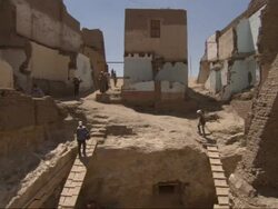 Wide Shot, crane - Workers use plank ladders to enter and exit an archeological dig / Egypt Stock Footage
