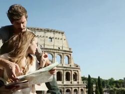 Tourists with guide and map in front of the Coliseum Stock Footage