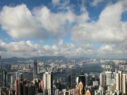 T/L Hong Kong lighting up, dusk to night, high angle view from Victoria Peak, Mount Austin,, Hong Kong Island across the harbour to Kowloon. Stock Footage