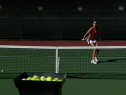 SLO MO, WS, Young woman playing tennis, tennis ball machine shooting balls in foreground, Santa Barbara, California, USA Stock Footage