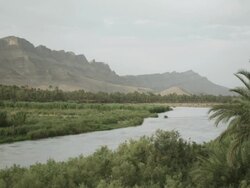 The wind blows as the Moroccan landscape is divided by a river. Stock Footage