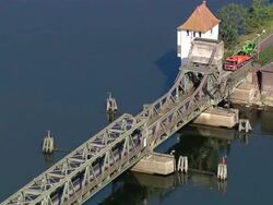 AERIAL MS ZI Cars and trucks crossing bridge / Schleimuende, Schleswig-Holstein, Germany Stock Footage