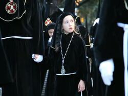 Young girl with Hooded Nazarenos parade during the celebration of Semana Santa a Holy week in Malaga Spain, Europe Stock Footage