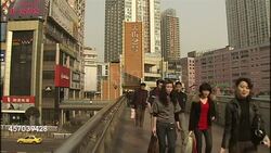 Commuters walking over bridge in Chongqing News Clip