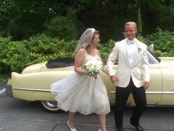 MS PAN Newlywed bride and groom waving and walking past classic convertible / Washington State, USA Stock Footage