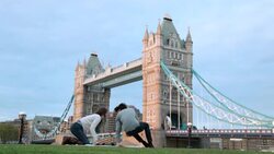 A young couple relax near the Tower Bridge in London. Stock Footage