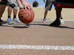 DS TS Dolly of male basketball players dribbling the basketball. Stock Footage