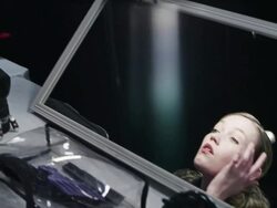 MS TU PAN Female fashion model backstage at fashion show looking at herself in mirror before turning to walk away Stock Footage