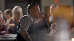 Bartender chats with customer while mixing drink Stock Footage