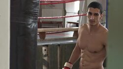 Boxer training in gym with punching bag Stock Footage