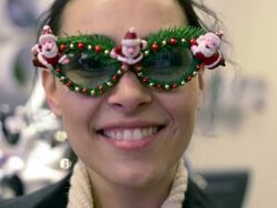 CU Shot of Woman smiling and laughing inside store wearing Christmas decorated glasses / Potsdam, Brandenburg, Germany  Stock Footage