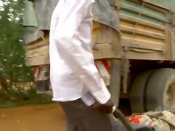 Man carrying sick child inside a wheel barrel Stock Footage