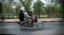 Family riding a bike, Lahore 1 Stock Footage
