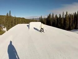 A skier does a backflip jump off a ramp at a ski resort. - Model Released - HD Stock Footage