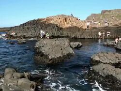 WS View of Visitors at Giant's Causeway on sunny day / Giant's Causeway, Northern Ireland, United Kingdom  Stock Footage