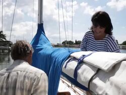 CU couple removing sail cover on yacht /tampa,florida,USA Stock Footage