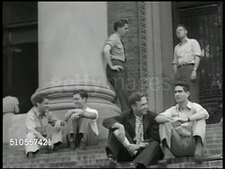 1950: COLLEGE CAMPUS: WS Columbia University Low Memorial Library building columns & steps, college students sitting & standing on steps, INT Library w/ students at tables, reading, researching, student standing w/ book by shelf.  Ivy League. Instructional Video