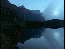 WA view of mountains reflected in still lake, Uganda, Africa Stock Footage