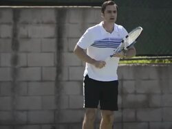 CU a male tennis player hitting the tennis ball forehand. Stock Footage