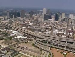 Aerial empty elevated I-90 highway and buildings in downtown area / New Orleans, Louisiana Stock Footage
