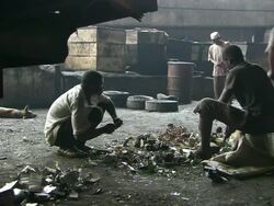WS View of men breaking up metal components / Lagos, Nigeria Stock Footage