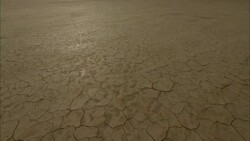 Cracked mud characterizes a dry, flat lake bed. Stock Footage