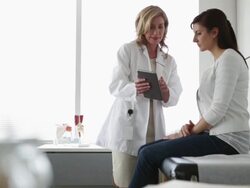 Doctor and patient looking at digital tablet Stock Footage