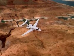 Aerial medium shot private jet flying through Grand Canyon / Arizona Stock Footage