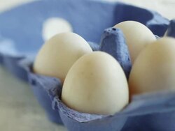 CU  PAN Shot of Hand taking duck egg from light blue carton / London, United Kingdom  Stock Footage