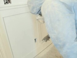 Painter Spraying Oil Paint on Bedroom Wainscoting Stock Footage