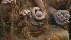 Straw hangs from a sculpture of an elephant with human arms. Stock Footage