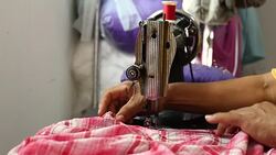 Seamstress Using Sewing Machine for making clothes Stock Footage