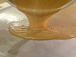 CU PAN  cooking vessel pours hot toffee mixture onto stainless steel cooling table / Rancho Mirage, California, USA Stock Footage