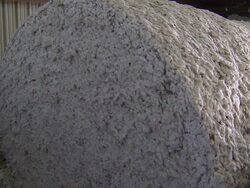 CU of bales of cotton moving through machine. Stock Footage