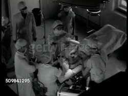 1944: CHINESE MEDICAL EDUCATION: WS Women walking up road toward university. INT Operating Room theater w/ patient being prepped for surgery. Future nurses, doctors, surgeons watching procedure below. Instructional Video