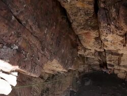 Handheld tilt of a rock-climber at the bottom a rectangular space. Stock Footage