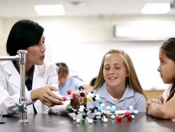 Teacher teaching young students in class. Slow pan. Stock Footage