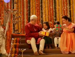Man and woman giving gifts to their grandchildren in diwali festival  Stock Footage