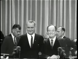U.S. President Lyndon B. Johnson and U.S. Senator Hubert Humphrey smile as they accept the presidential candidate nomination during the 1964 Democratic National Convention. News Clip
