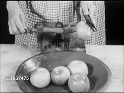 MOT: EARLY AMERICANA: HOMEMAKING REENACTMENT: MS Female hands using table mounted apple parer, placing apple on spindle, turning crank while holding blade on apple, peeling. CU Face of middle-aged woman in Colonial period clothing, bonnet, looking down Instructional Video