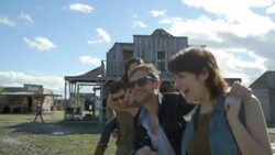 Group of friends walk away from Texas ghost town Stock Footage