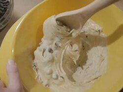 CU Shot of Cookie dough mixing with chocolate chips in yellow bowl / Los Angeles, California, United States Stock Footage