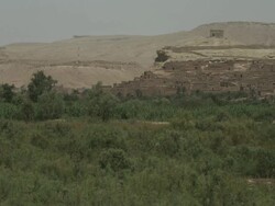 Rustic, hillside dwellings stretch out of the thick greenery below. Stock Footage