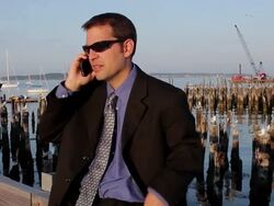 MS Man talking on mobile phone near harbor / Portland, ME, United States Stock Footage