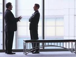  WS Business associates standing and talking in lobby, then shaking hands and leaving / Seattle, Washington, United States Stock Footage