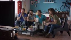 Guys sitting on couch watching tv disappointed Stock Footage